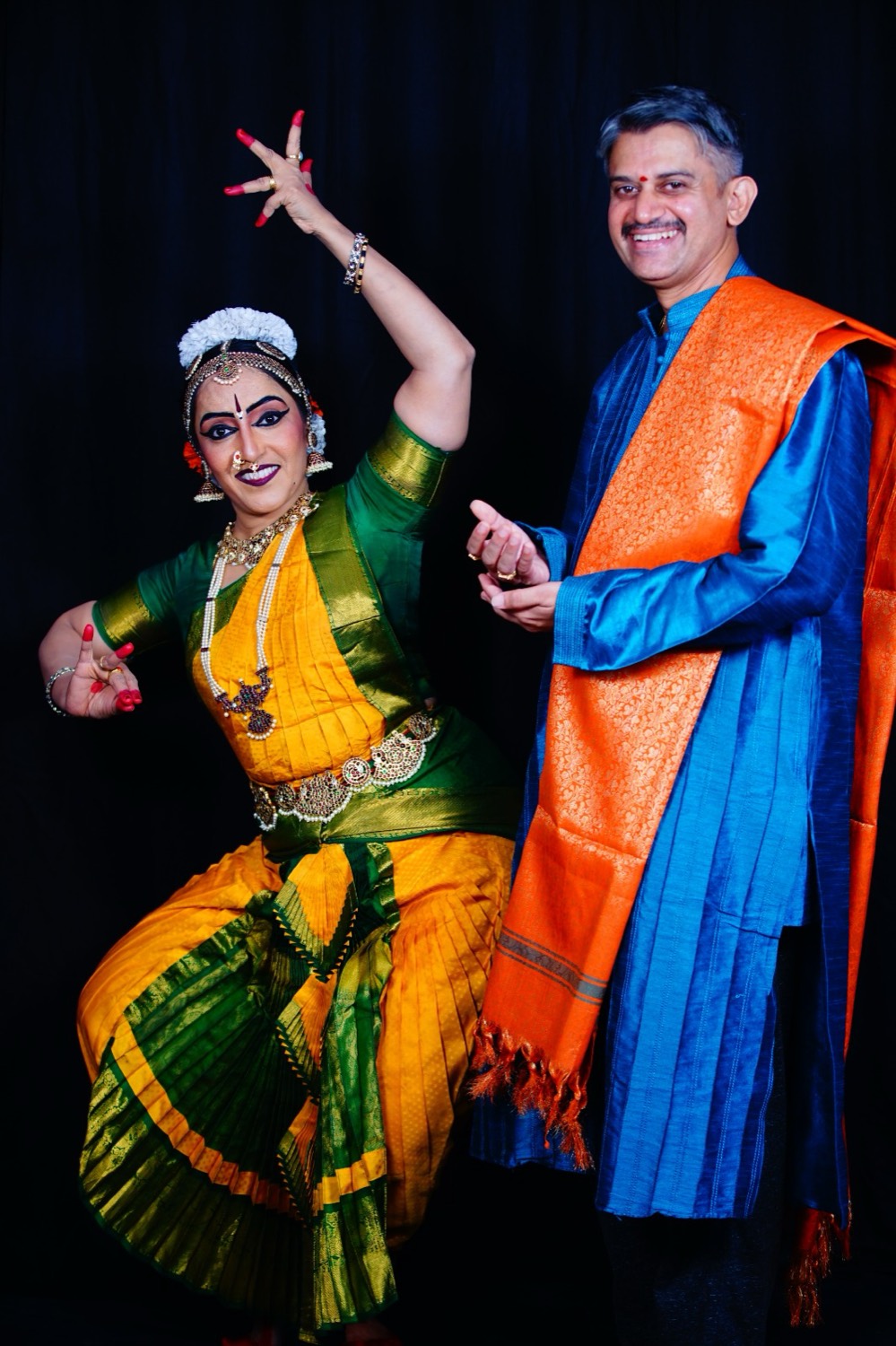 Vidushi Mithra Naveen in a dance pose beside Vidwan M. S. Naveen