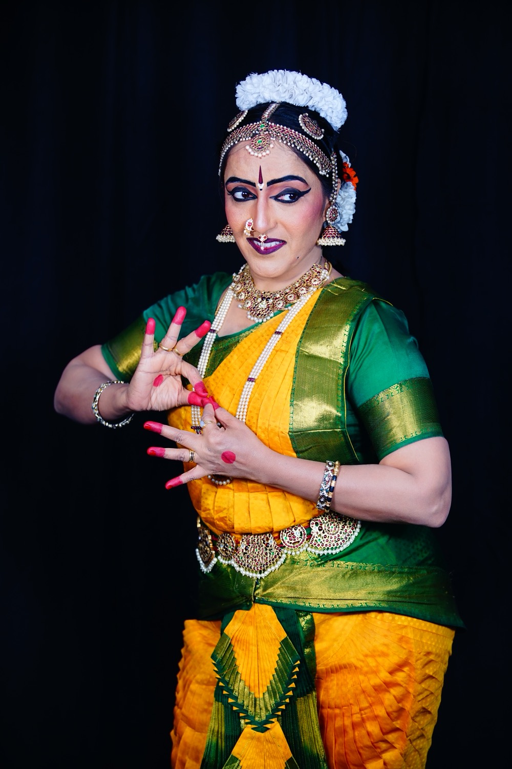 Vidushi Mithra Naveen in Bharatanatyam costume, hands in a mudra